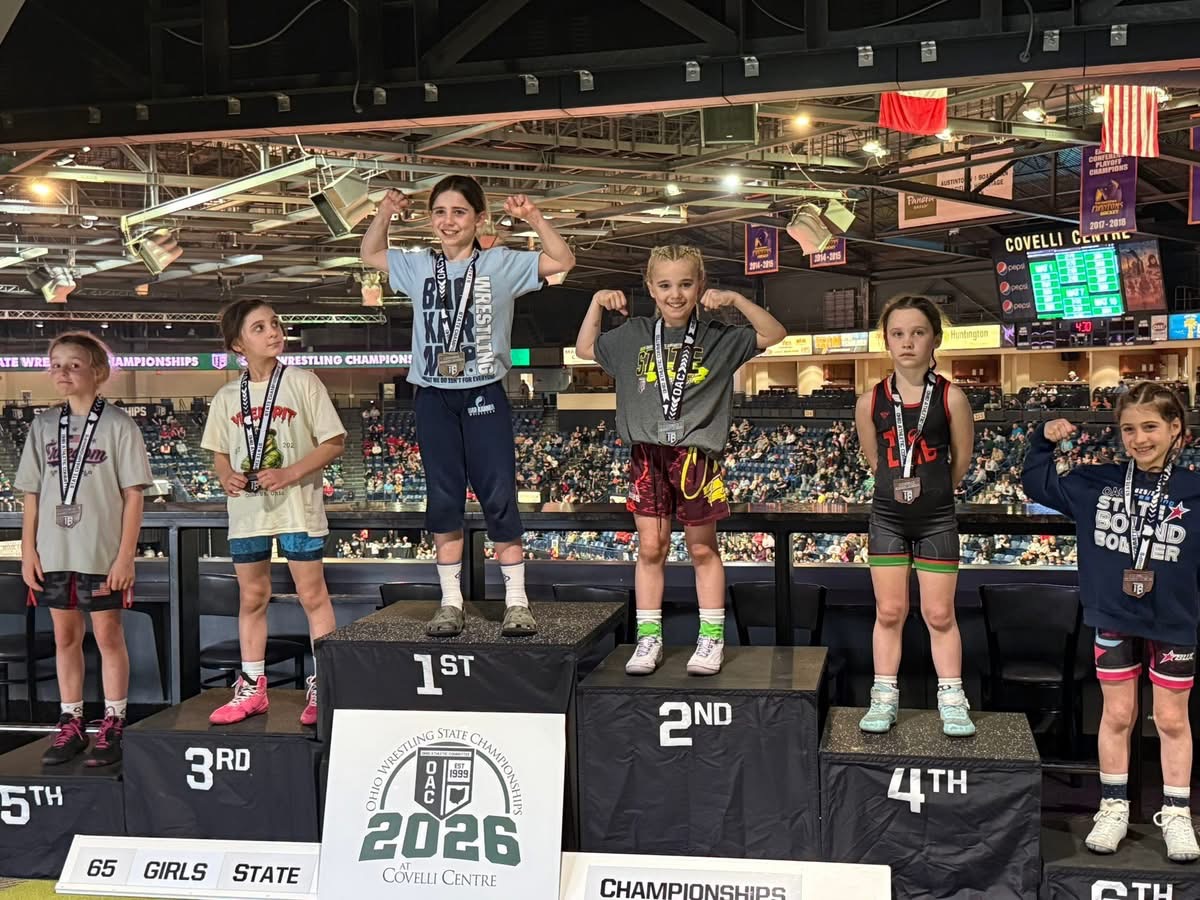 Wrestlers standing on OAC girls state podium